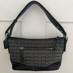 Coach bag gray fabric with black C’s and leather trim.